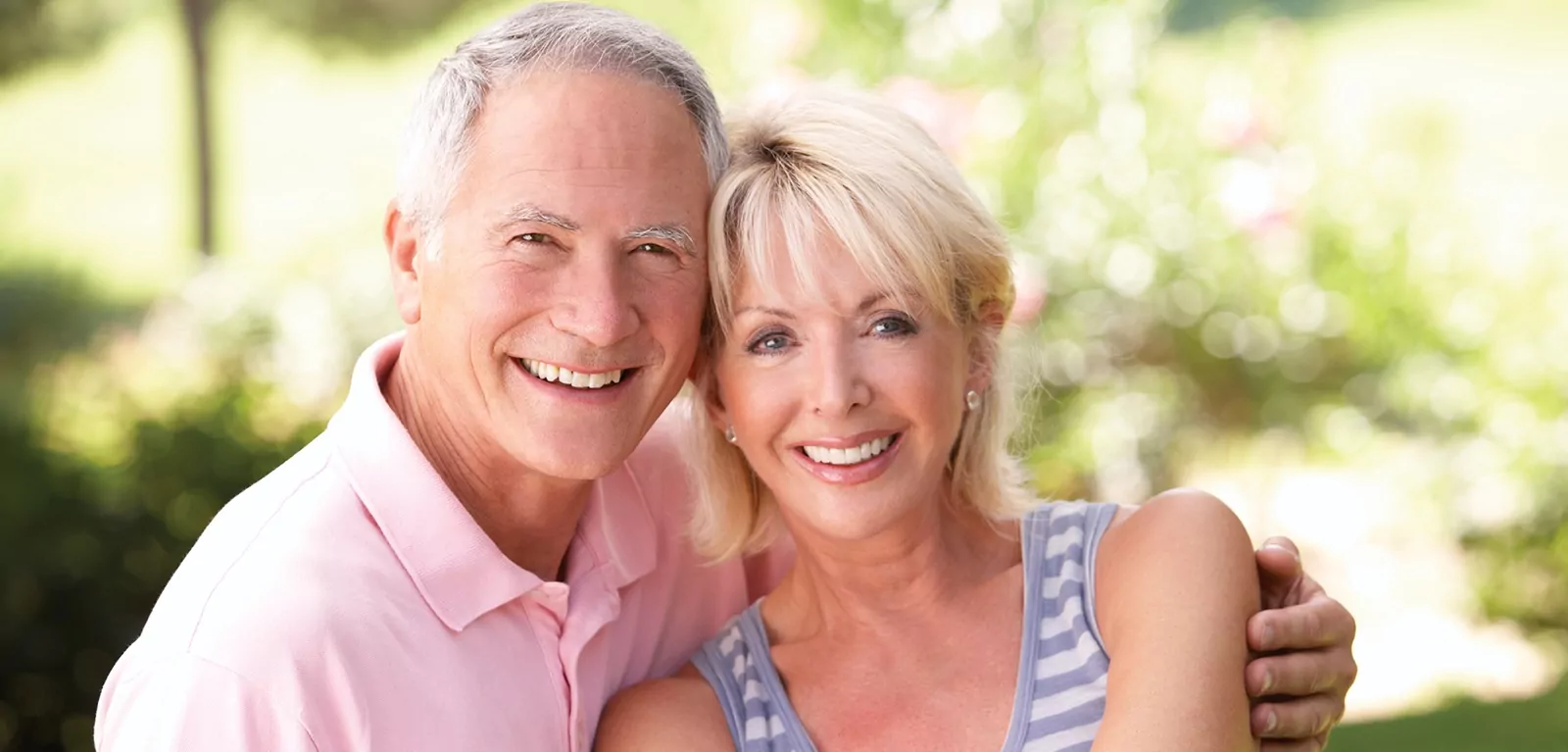 A senior couple enjoy their new smile with dental implants